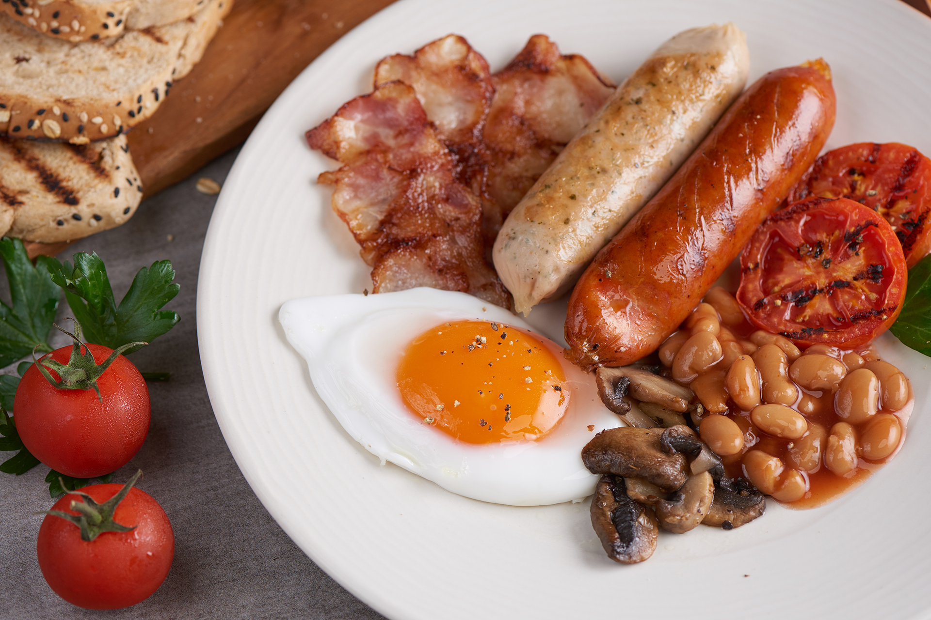 Traditional full English breakfast with eggs, sausages, and beans.